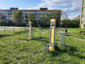 a row of exercise equipment in a park at Apartament Bella in Bolesławiec
