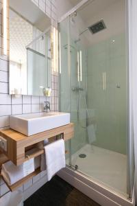 a bathroom with a sink and a shower at Hôtel Marin in Laval