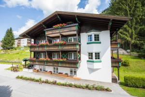 a white building with flowers on the balconies at Villa 7 in Flachau