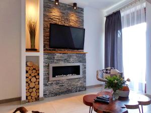 Televízia a/alebo spoločenská miestnosť v ubytovaní Apartament Makalu + 8 fotografií