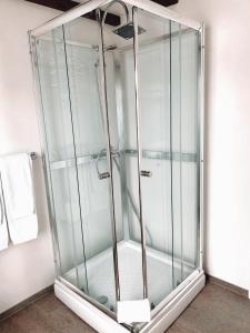 a shower stall with glass doors in a bathroom at Grand Guesthouse Gardakot in Gardakot