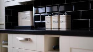 a counter with books sitting on top of it at Elegant Apartment in Kent