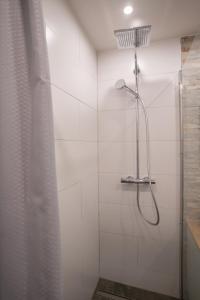 a bathroom with a shower with a shower curtain at Waldrausch Titisee in Titisee-Neustadt +7 photos