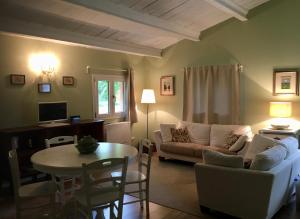 a living room with a couch and a table at Corte San Giuliano in Correzzola