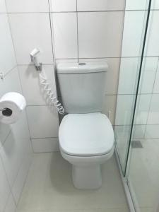 a bathroom with a toilet and a roll of toilet paper at Kitnet na Boa Vista, Recife - 508 in Recife