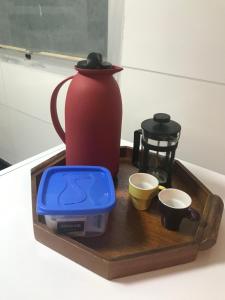 een dienblad met een waterkoker en kopjes op een aanrecht bij BrunoApartamentos Recife - Boa Vista - Apt 508 (temporada) in Recife