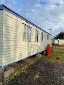 a white trailer is parked in a yard at G4 Holiday Caravan in Par