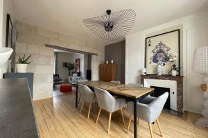 a dining room with a table and chairs and a fireplace at Superb duplex near the Halles de Tours in Tours