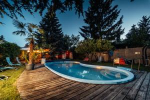 a swimming pool on a wooden deck at Buddha Residence in Sopron