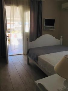 a bedroom with a bed and a sliding glass door at The White Hotel Alaçatı in Alaçatı