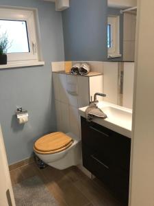 a bathroom with a toilet and a sink at Sandstrand in Wismar