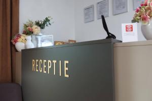 a reception desk with a sign that reads receipts at Casa Lacul Doamnei in Ocnele Mari