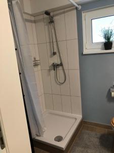 a bathroom with a shower with a shower curtain at Sandstrand in Wismar