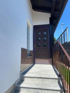 a wooden door on a building with stairs at Apartment Mia in Neusiedl am See