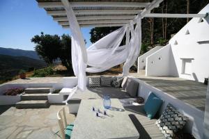 a patio with a table and chairs under a pergola at Saffron Boutique in Krokos