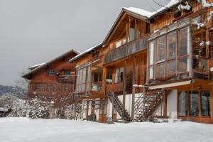 a log home in the snow with a staircase at Haus Klebern, Egg - im Zentrum des Bregenzerwaldes in Egg