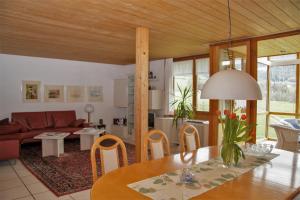 a living room with a table and a couch at Haus Klebern, Egg - im Zentrum des Bregenzerwaldes in Egg