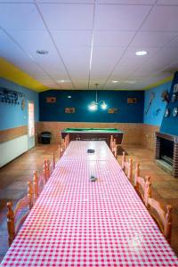 una mesa de billar en una habitación con un mantel rojo y blanco en CASA RURAL ADELA, 