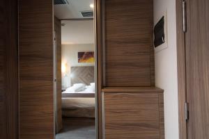 Postel nebo postele na pokoji v ubytování Hotel Aroi Ponferrada