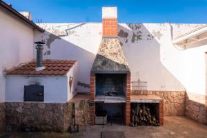 a fireplace in a building with a pizza oven at CASA RURAL ADELA 