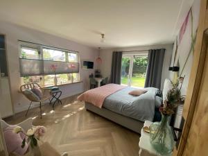 a bedroom with a bed and a window at Paauwze in Rijnsburg