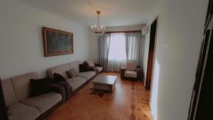 a living room with a couch and a table at On Khimshiashvili Apartment in Batumi