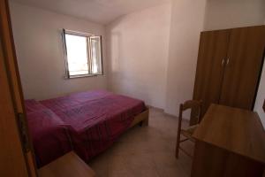 ein kleines Schlafzimmer mit einem Bett und einem Fenster in der Unterkunft Fondaco del Capo in Capo Vaticano