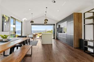 a kitchen and dining room with a table and chairs at Raptor's Haven - Kinloch Holiday Home in Kinloch