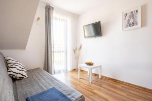 Telewizja i/lub zestaw kina domowego w obiekcie Apartamenty Plazowa