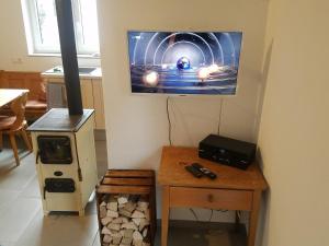 a living room with a stove and a tv on the wall at Alte Brennerei in Bissingen an der Teck