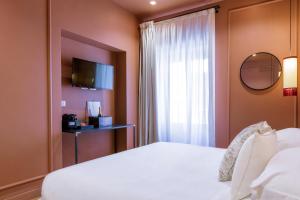 a bedroom with a white bed and a window at The Couper Colonna in Rome +61 photos