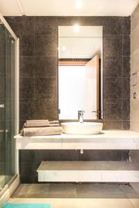 a bathroom with a sink and a mirror at Privat Apartments Prestigia Hay Riad in Rabat