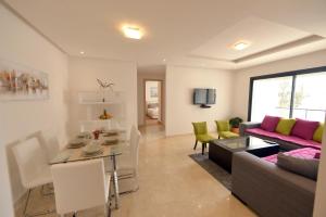 a living room with a couch and a table at Privat Apartments Prestigia Hay Riad in Rabat