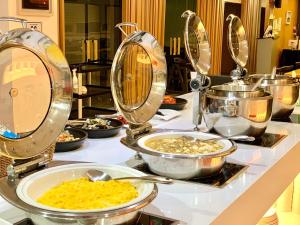 a buffet with many plates of food on a table at Co-op City Hotel Seongsan in Seogwipo