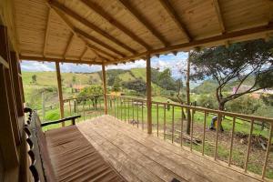 a wooden porch with a view of the mountains at Un refugio en las montañas de Tabio in Tabio