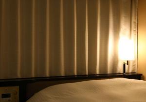 Krevet ili kreveti u jedinici u objektu APA Hotel Nagoya Ekimae