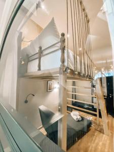 a room with two bunk beds and a chair at Petite Dalat - Boutique Hotel in Da Lat +107 photos