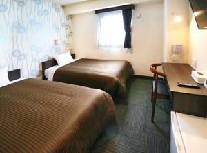 Postel nebo postele na pokoji v ubytování Hotel Trend JR Uji Ekimae