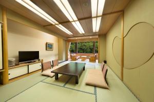a dining room with a table and chairs at Minakami Hotel Juraku in Minakami