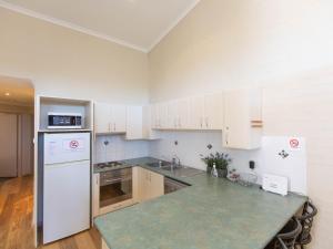 a kitchen with white cabinets and a counter top at Acacia 5 2 Kirwan Close in Jindabyne