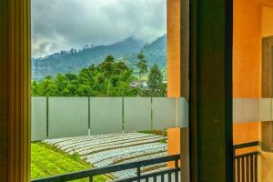 a balcony with a view of a mountain at RedDoorz near Agrowisata Kebun Teh Dieng in Wonosobo