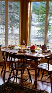 een tafel met borden eten voor een raam bij The Poplar Inn in Banff