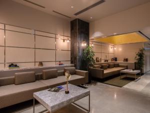 a lobby with couches and a table in a room at HOTEL TORIFITO KANAZAWA in Kanazawa