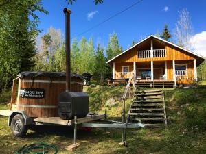 a house on a trailer in front of a house at Iken Mökit in Heinola +51 photos