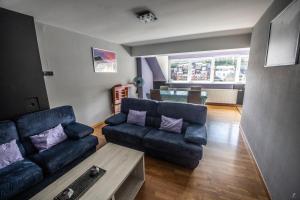 a living room with a couch and a table at L'Inattendu "sur la croisette" Dinant centre in Dinant