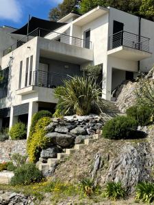 a house on top of a hill with stairs at Villa Petrera in Valle-di-Campoloro