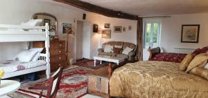 a bedroom with a bed and a bunk bed at Wisteria House in Chanteloup