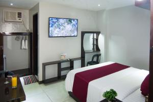 En eller flere senge i et værelse på Diamond Hotel And Resto