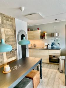 a kitchen with a dining table and a kitchen with cabinets at Poppenberg Lodge in Winterberg