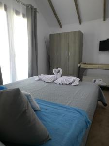 a bedroom with a bed with a bow on it at Armonia Apartment in Potos